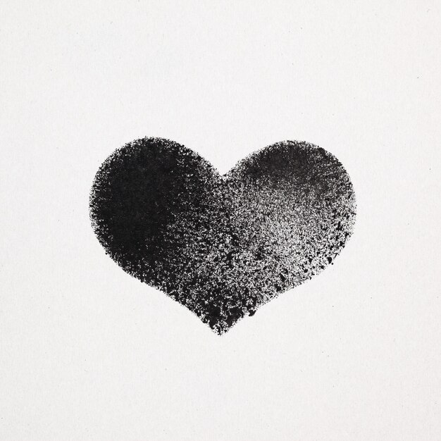 Black stenciled heart on gray cardboard