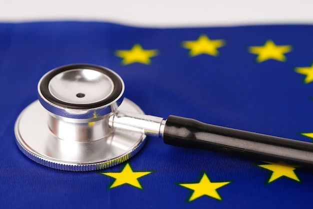 Black stethoscope on EU flag background.