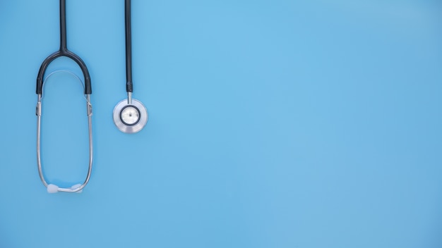 Black stethoscope folded, in a bright blue background