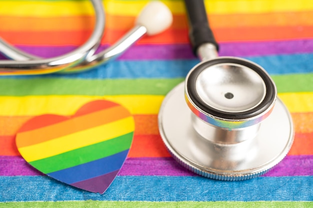 Black stethoscope on rainbow flag with heart symbol of LGBT pride month celebrate annual in June social symbol of gay lesbian bisexual transgender human rights and peace