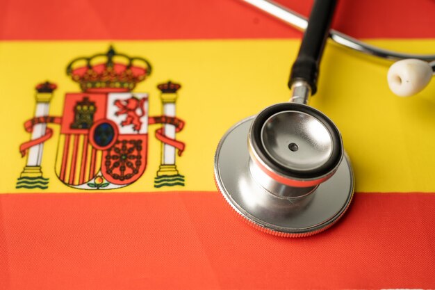 Photo black stethoscope on spain flag background, business and finance concept.