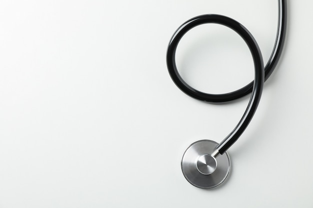 Black stethoscope on white background, close up. Healthcare