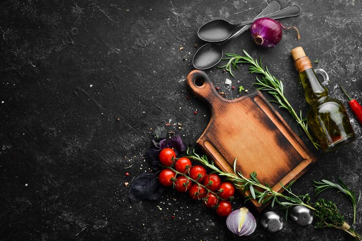 Black stone background kitchen board vegetables and spices Top view Free copy space