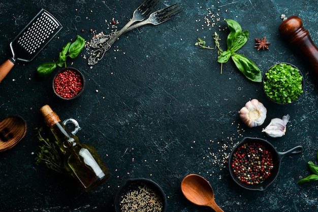 Black stone culinary background with vegetables and spices Top view Rustic style