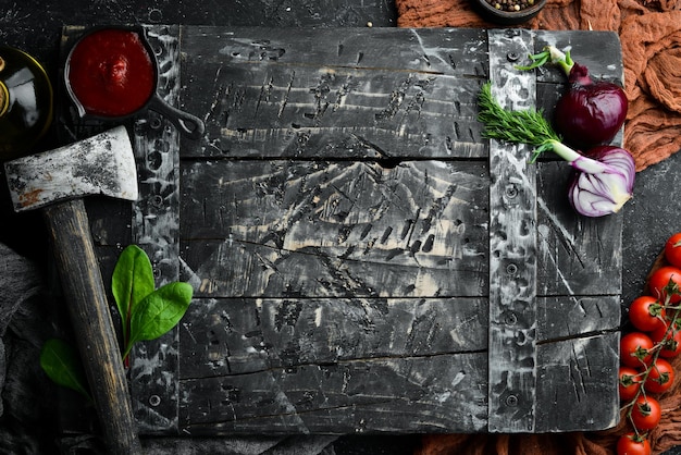 Black stone food background Vegetables and spices on black old table