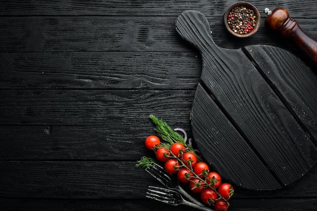 Black stone food background Vegetables and spices on black old table