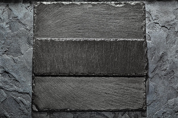 Photo black stone slate plates on dark background mockup for your menu