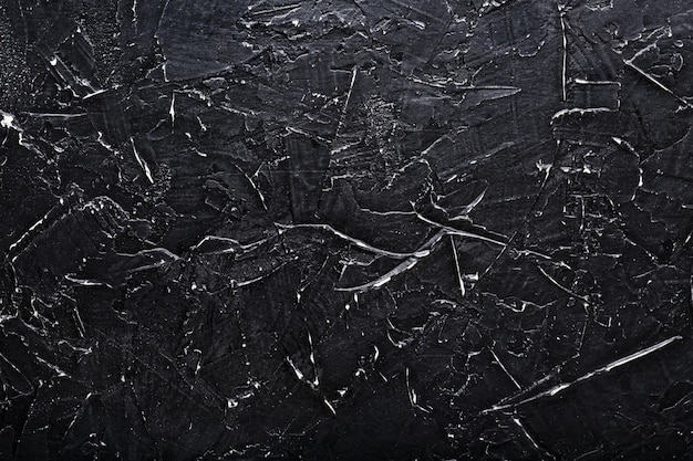 Black Stone texture wall with white scratches. Full screen as