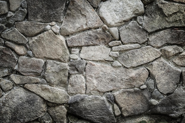 Black stones and rocks of different shape gray background