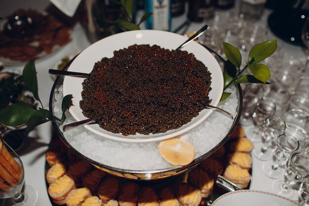 Black sturgeon caviar on the table in a restaurant.