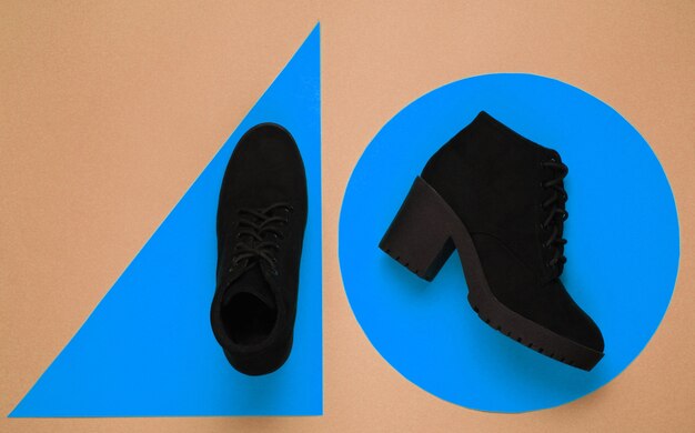 Photo black suede boot on geometric shapes. minimalistic fashion still life. flat lay. top view