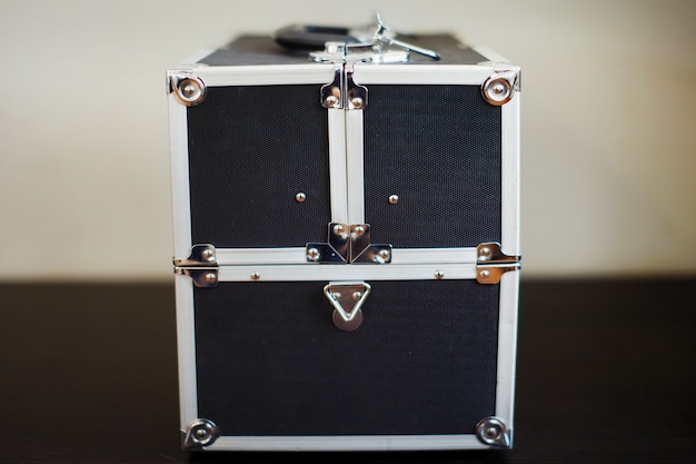 Black suitcase with aluminum reinforced corners and ribs.