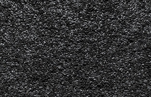 Black sunflower seeds background above view