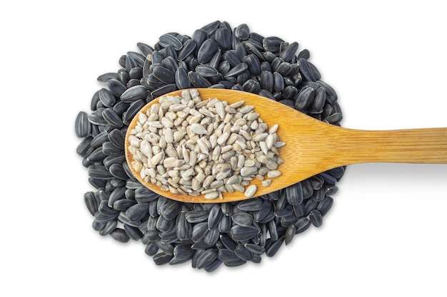 Black sunflower seeds with a wooden spoon isolated on a white background