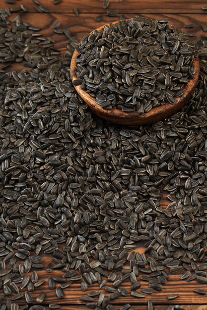 Black sunflower seeds on wooden table