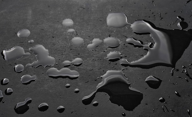 A black surface with water droplets on it