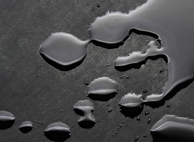 A black surface with water drops on it