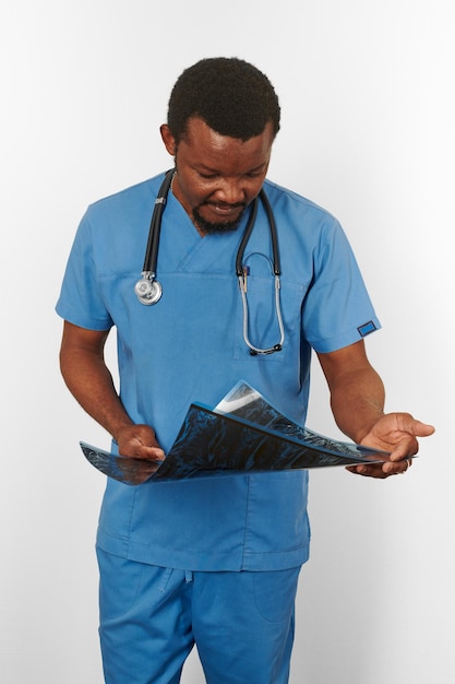 Black surgeon doctor bearded man in blue coat with crossed arms isolated white background copy space