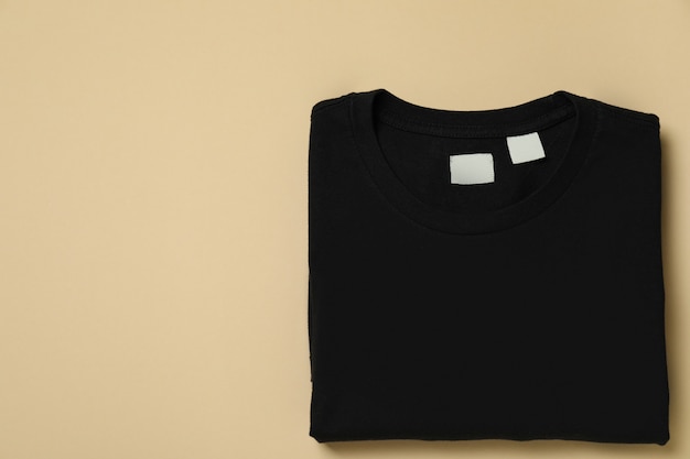 black sweatshirt on beige surface