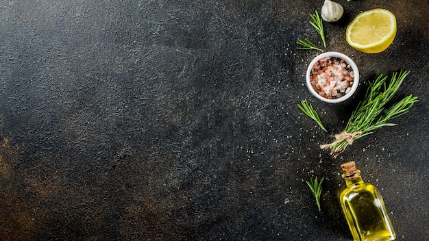 A black table with a black tablecloth and a few herbs.