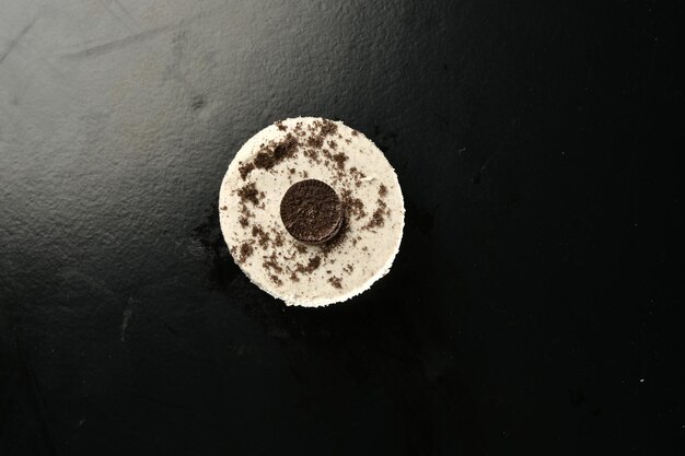 A black table with a oreo cookie on it