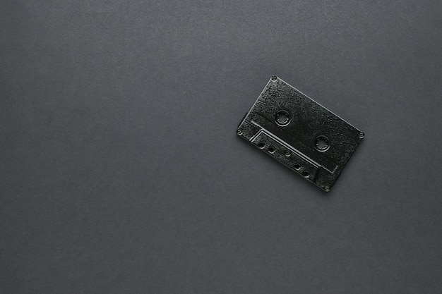 A black tape recorder on a black background. Vintage recording technique. Vintage musical style.