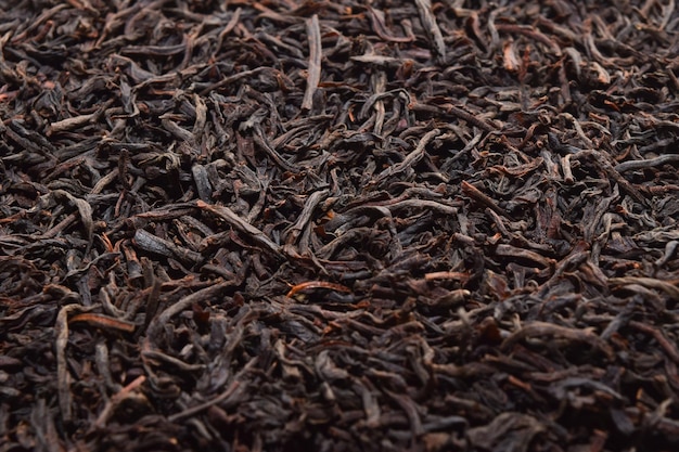 Черный чай фон сушеный черный чай Английский завтрак Ингредиенты чая Цейлонский черный чай крупным планом вид сверху