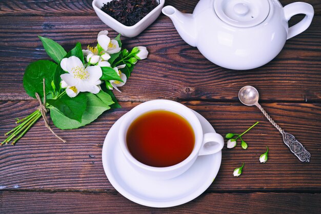 Black tea and a bouquet of blossoming jasmine 