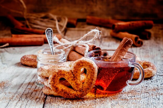 Black tea and cookies with cinnamon selective focus