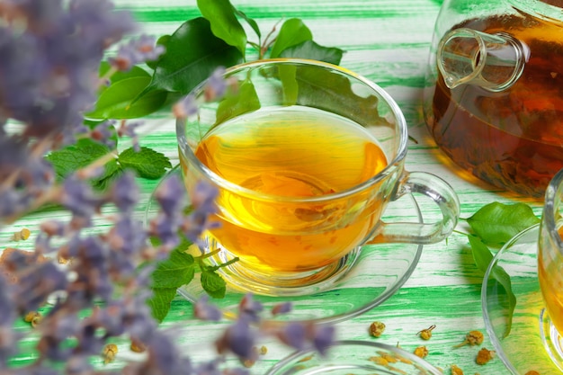 Black tea on green wooden background