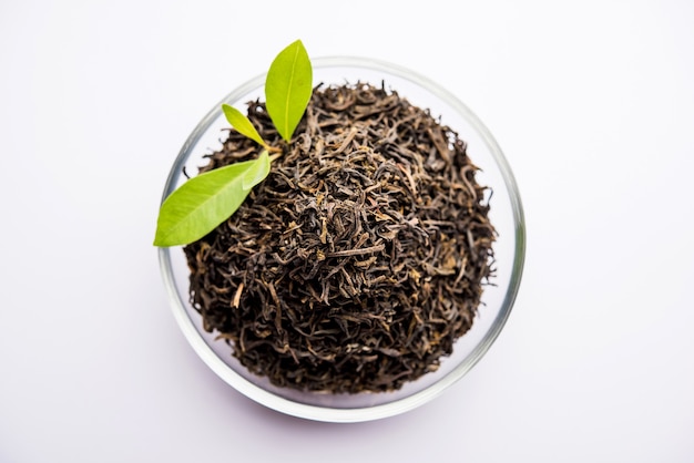 Black Tea Powder or dry dust with or without green leaf and served hot chai in a cup