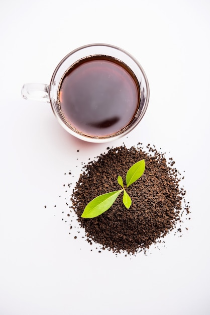 Black Tea Powder or dry dust with or without green leaf and served hot chai in a cup