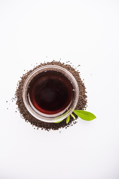 Black Tea Powder or dry dust with or without green leaf and served hot chai in a cup