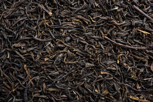 Black Tea Powder or dry dust with or without green leaf and served hot chai in a cup