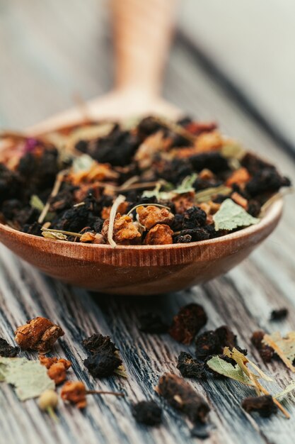 Black tea with herbs on a wooden board 