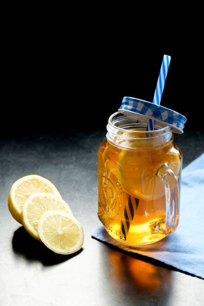 Black tea with lemon in jar cup