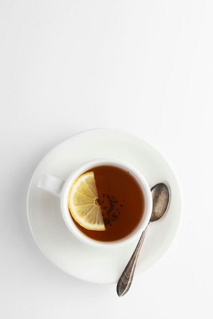 Black tea with lemonnd honey on white. 