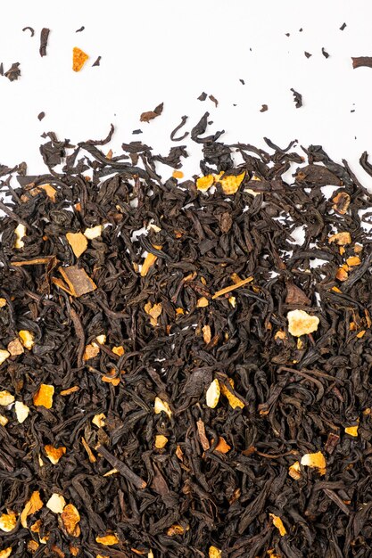 Black tea with orange peel and cinnamon closeup top view