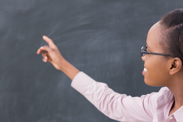 Black teacher pointing the blackboard