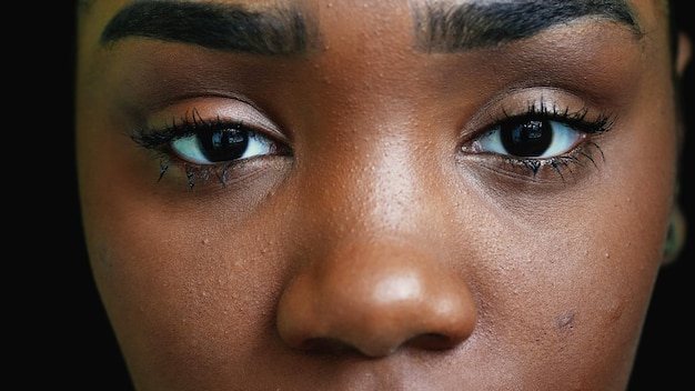 A black teen girl closing eyes in meditation person opening eye
macro closeup