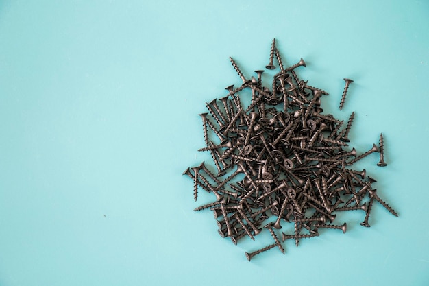 Black threaded screw on the green background, high angle view