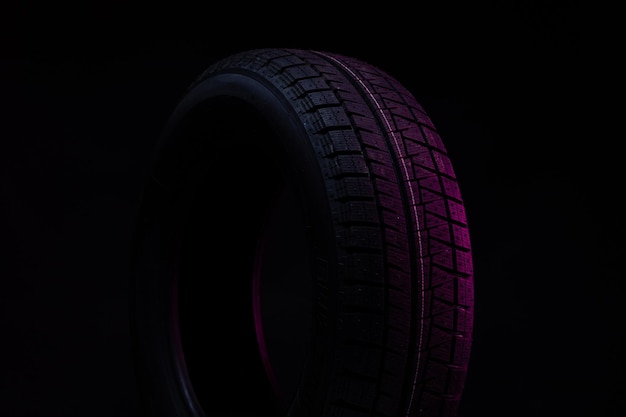 Black tire on stylish blue red background