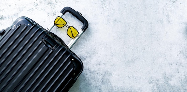 Black travel bag,black luggage set on dark background, top view
image, flat lay composition. travel