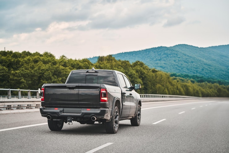 Photo black truck on a highway with a scenic backdrop