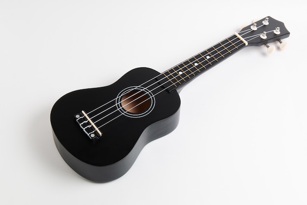 Photo black ukulele guitar on white