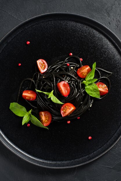 Black vegetarian pasta with Basil and cherry tomatoes. 