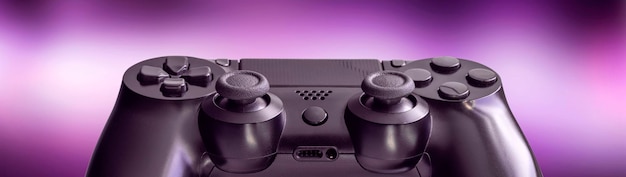 Black video game controller isolated on a blurred lilac background technology and video game concept