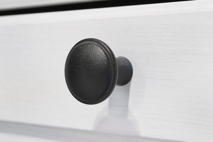 Photo black vintage furniture handle closeup on white wood background