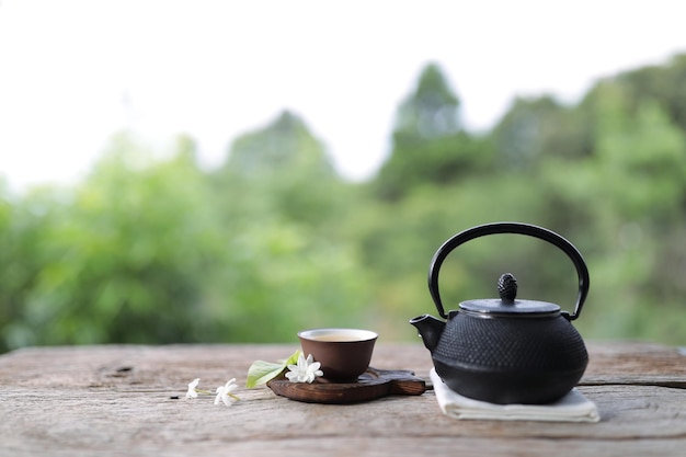 Black vintage teapot and cup at outdoor