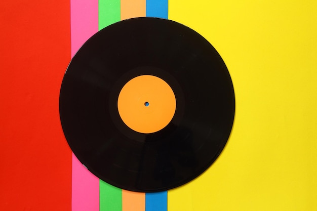 Black Vinyl record on a colorful background Retro style Top view